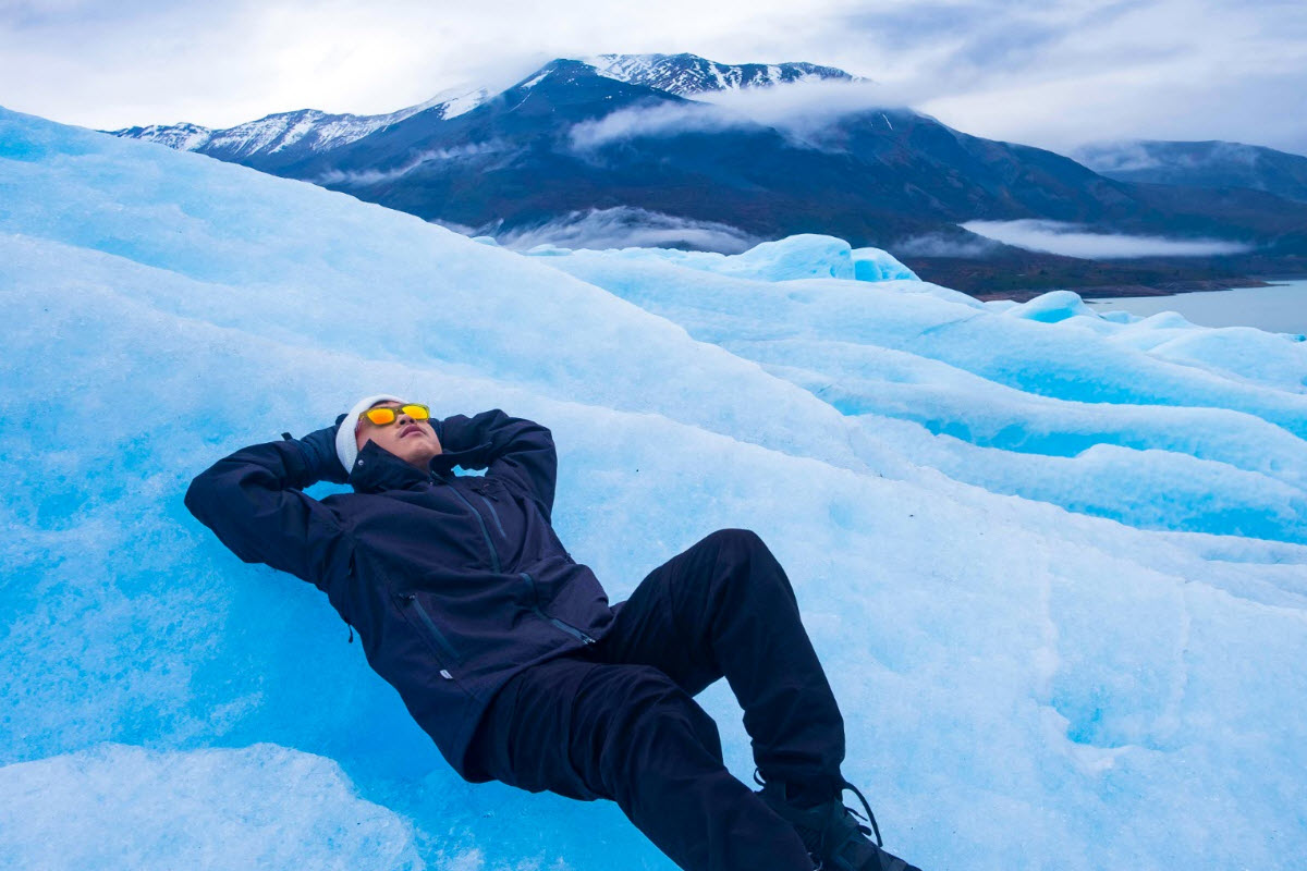Relaxing on blue ice at Solheimajokull Glacier