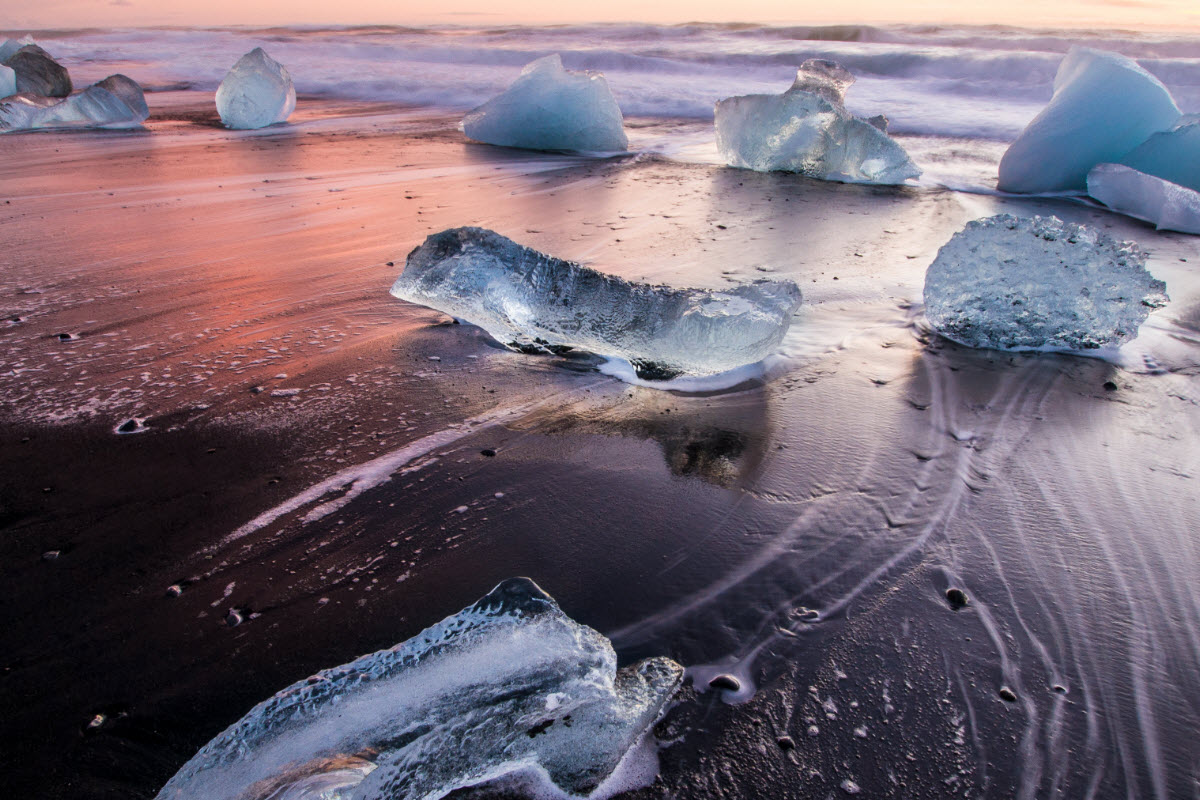 Ice on the black volcanic beach near Jokulsarlon glacier lagoon in Iceland