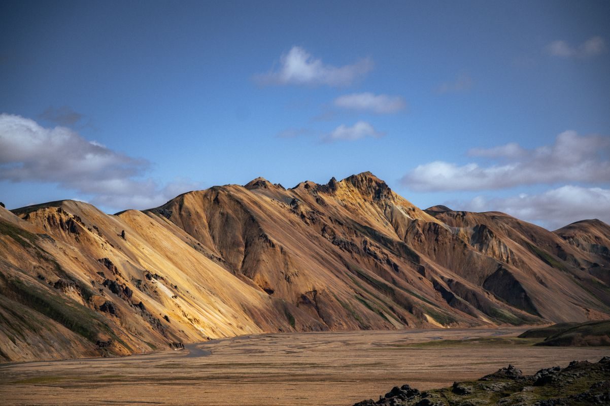 Highland road beside a blue crater lake on the route to Landmannalaugar