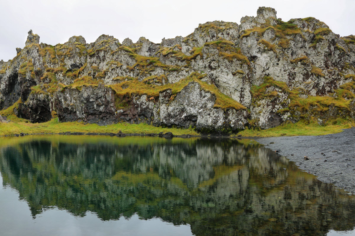 The Green Lagoon at the black sand beach of Djupalonssandur in Iceland