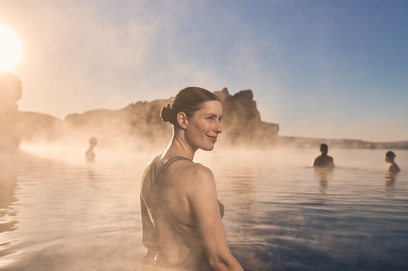 Guests relaxing in Sky Lagoon beside the Atlantic Ocean near Reykjavik
