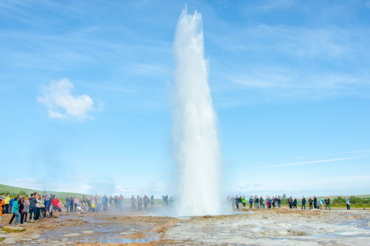 Strokkur hot spring spouts water about 30 meters high in the air