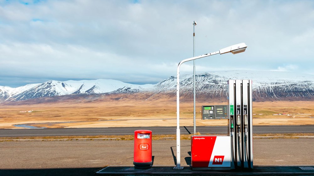 A rural fuel station surrounded by Icelandic mountains