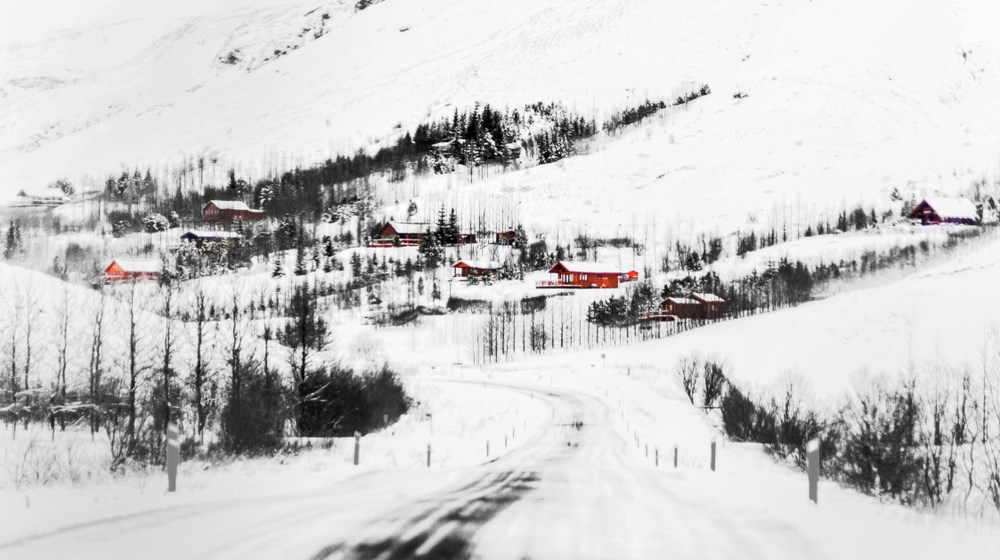 Snow-covered winter road in rural Iceland