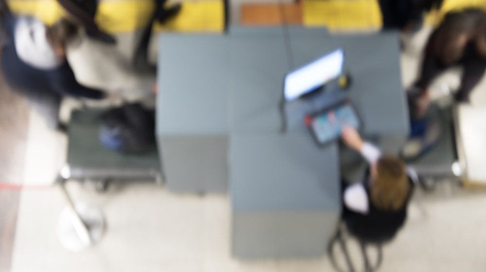 Traveler placing luggage through an airport screening machine