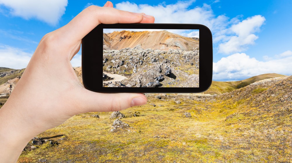 Smartphone in the remote Landmannalaugar landscape of the Icelandic Highlands