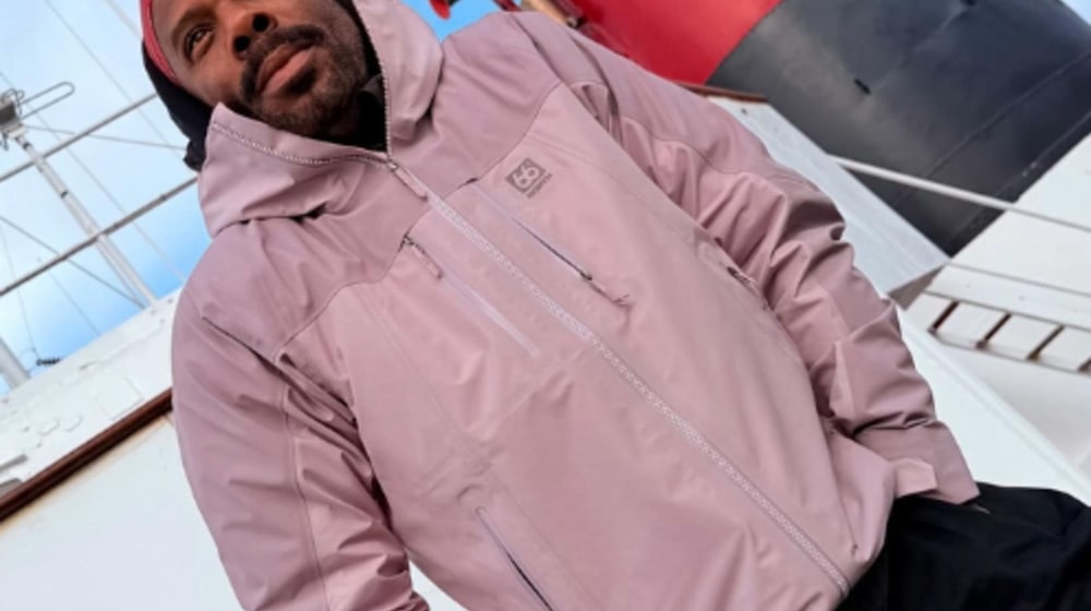 Colman Domingo in Iceland wearing a pink outdoor jacket