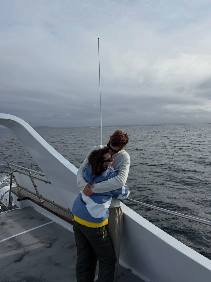 Millie Bobby Brown and Jake Bongiovi embracing aboard a whale-watching boat in Iceland