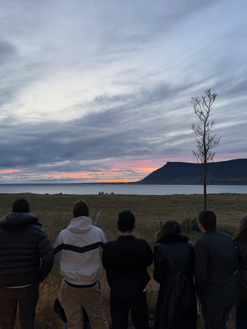 Friends looking across Hvalfjörður at sunset